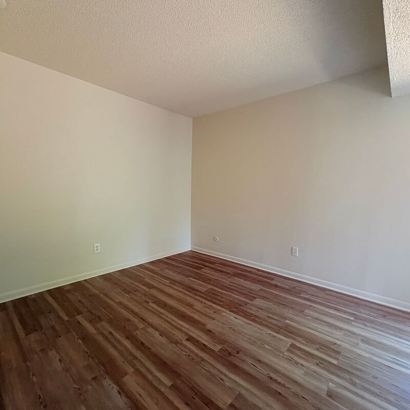 Spacious bedroom with new flooring and fresh paint